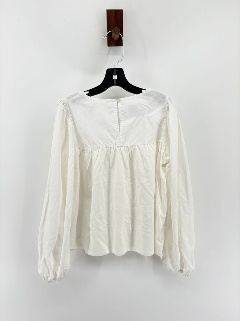 Tags on, long sleeve ruffle details