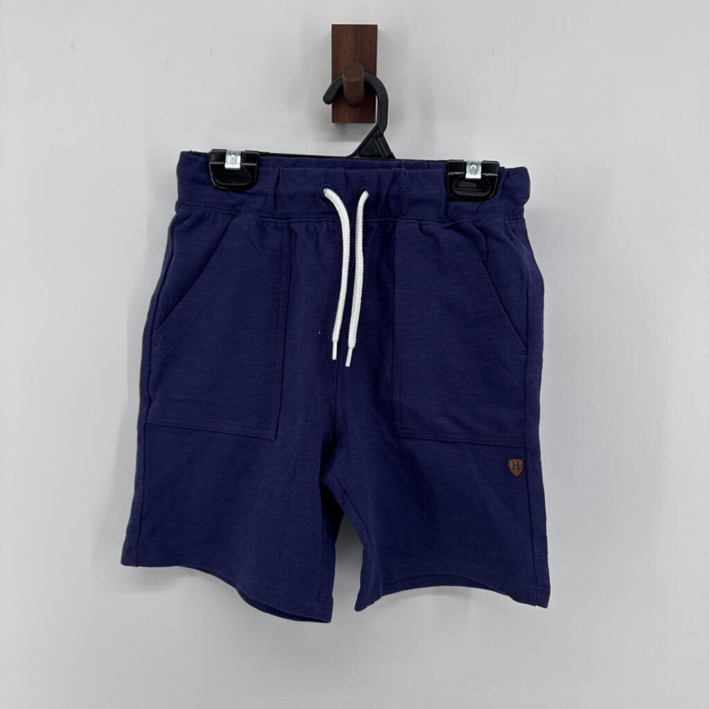 Tags on, polo t-shirt and chino pants