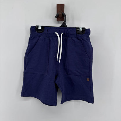 Tags on, polo t-shirt and chino pants