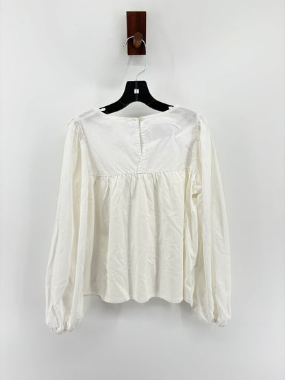 Tags on, long sleeve ruffle details