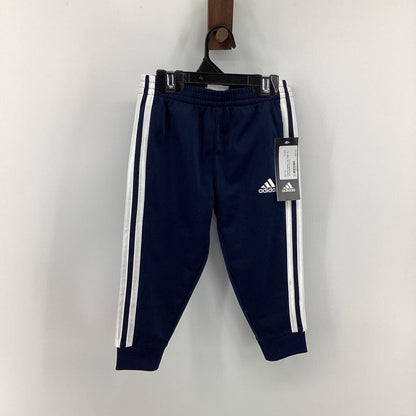 Tags on, track pants