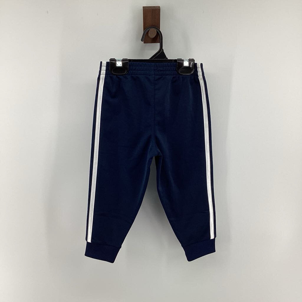 Tags on, track pants
