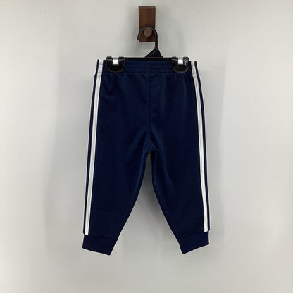 Tags on, track pants